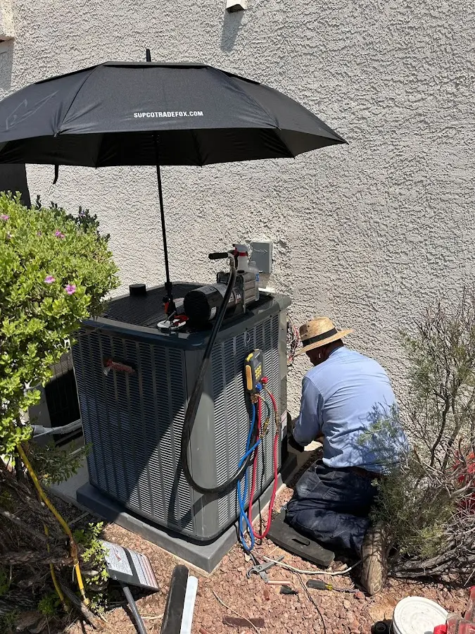 HVAC technician performing outdoor AC maintenance in Mason